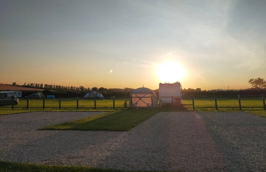 Sunset over a pitch with an awning