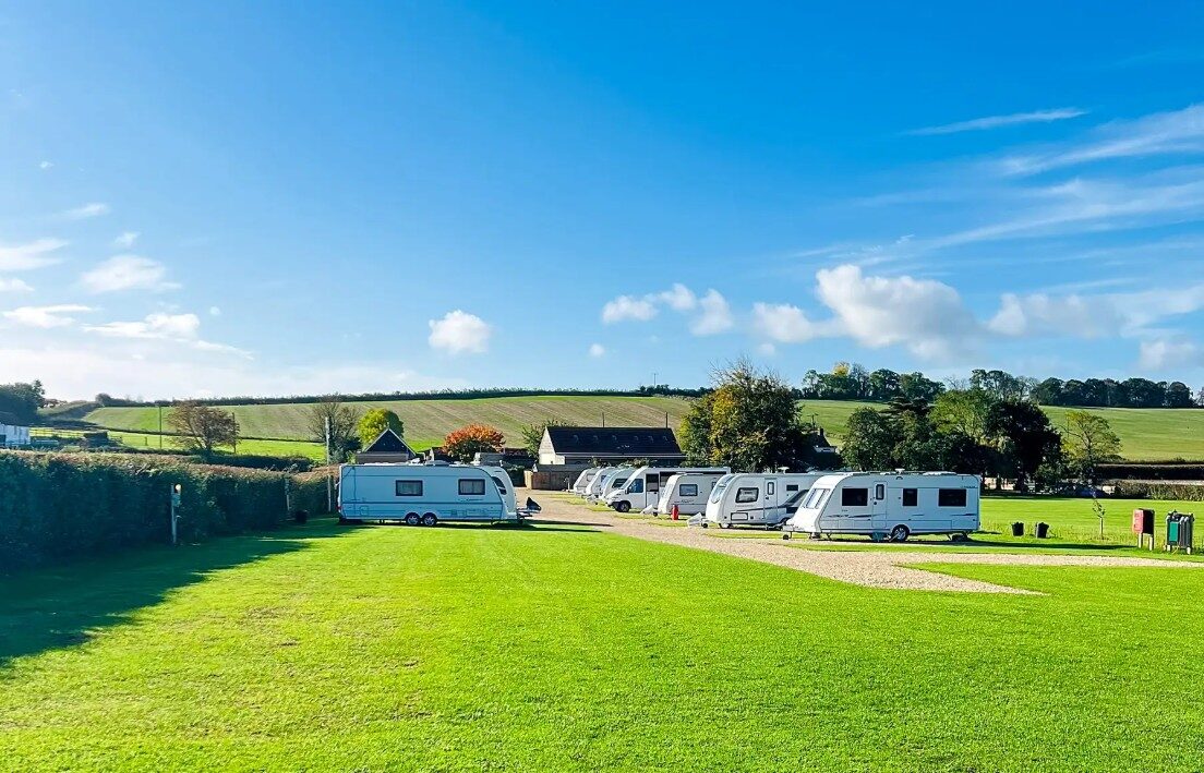 Caravans on their pitches on a bright autumn morning